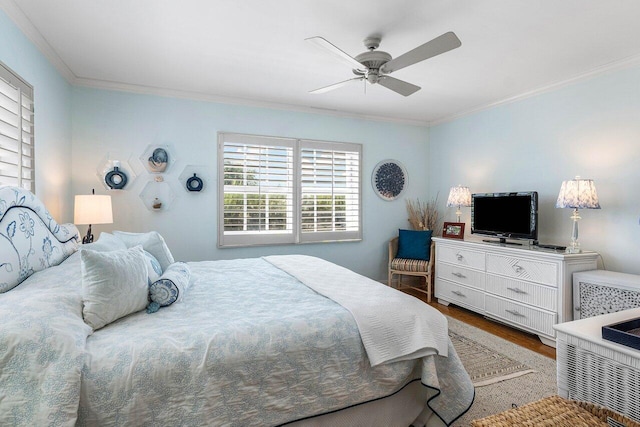 bedroom featuring ornamental molding, wood finished floors, and ceiling fan