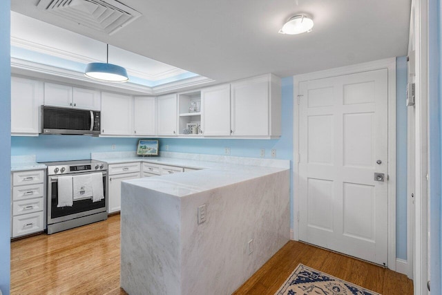 kitchen with visible vents, a peninsula, stainless steel appliances, a raised ceiling, and open shelves
