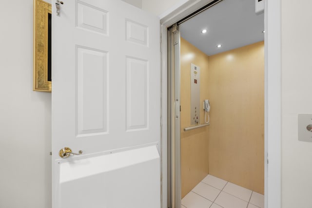 bathroom featuring recessed lighting, elevator, and tile patterned flooring