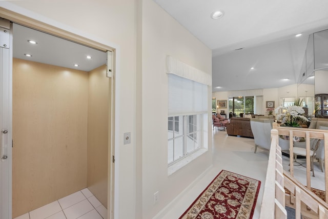 hallway with recessed lighting and elevator