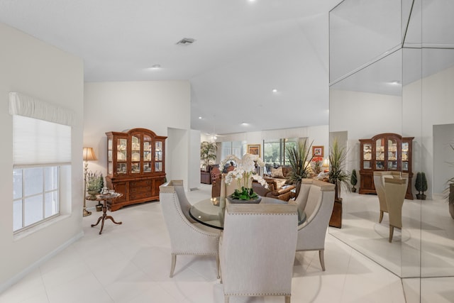 dining room with high vaulted ceiling and visible vents