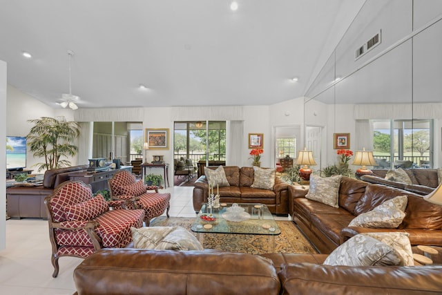 living area featuring plenty of natural light, a ceiling fan, lofted ceiling, and visible vents