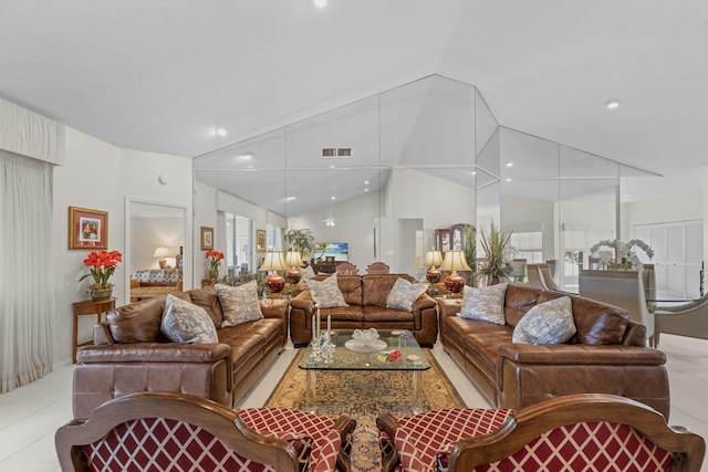 living area featuring visible vents, lofted ceiling, recessed lighting, light tile patterned floors, and a wealth of natural light