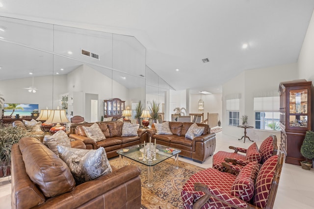 living area with visible vents, recessed lighting, light tile patterned floors, and high vaulted ceiling
