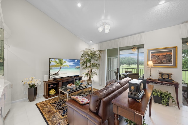 living area with baseboards and vaulted ceiling