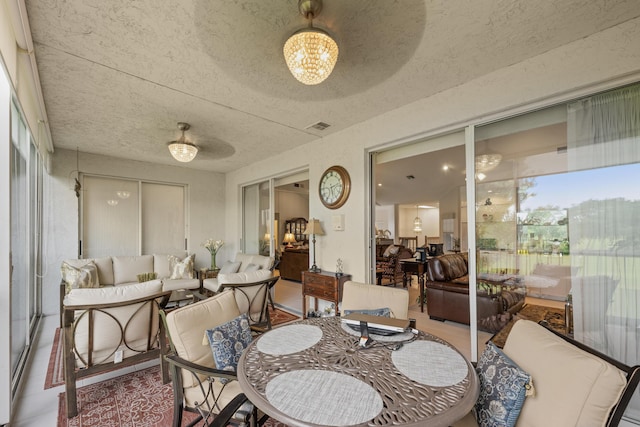 dining area featuring visible vents, a textured ceiling, and a chandelier
