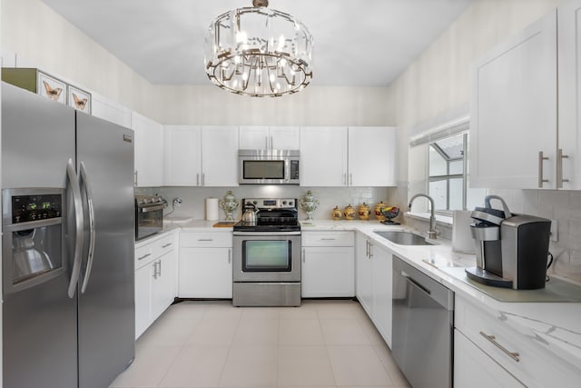 11602 Briarwood Cir Unit 4, Boynton Beach, FL 33437 - kitchen featuring stainless steel appliances, white cabinetry, and a chandelier