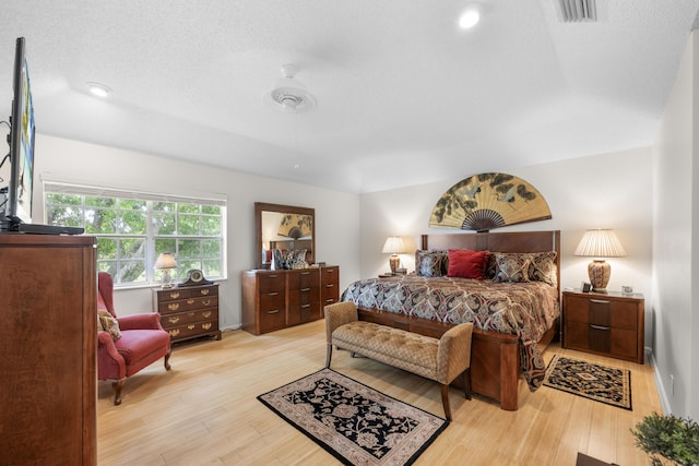 bedroom featuring recessed lighting, visible vents, and light wood-type flooring