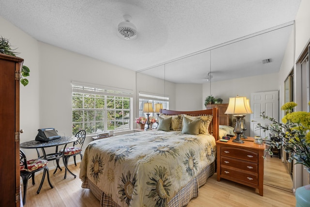 11602 Briarwood Cir Unit 4, Boynton Beach, FL 33437 - bedroom with light wood-type flooring and a textured ceiling