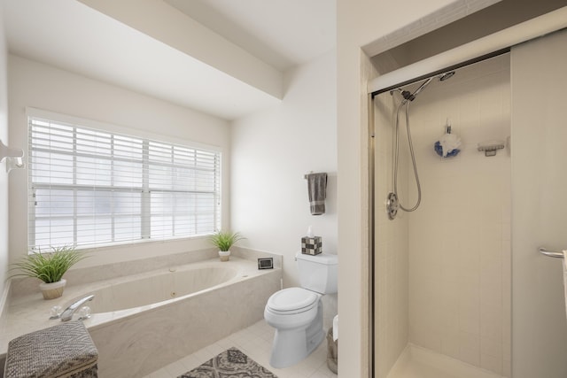 bathroom with a garden tub, tile patterned floors, toilet, and a shower stall