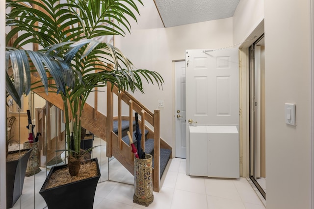 hall with stairs and a textured ceiling