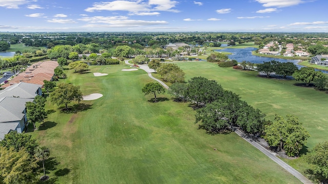 birds eye view of property with a water view, a residential view, and golf course view