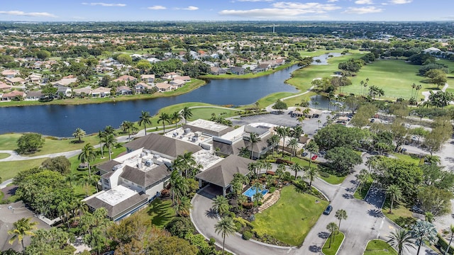 aerial view featuring a water view, view of golf course, and a residential view