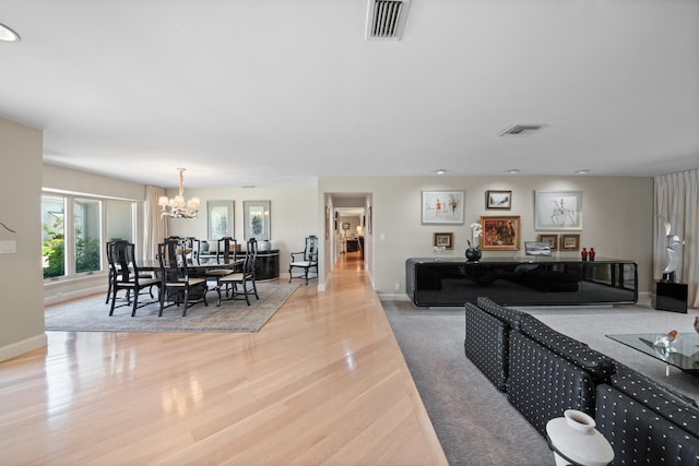 7 Inlet Cay Dr, Ocean Ridge, FL 33435 - living room featuring an inviting chandelier, baseboards, visible vents, and wood finished floors
