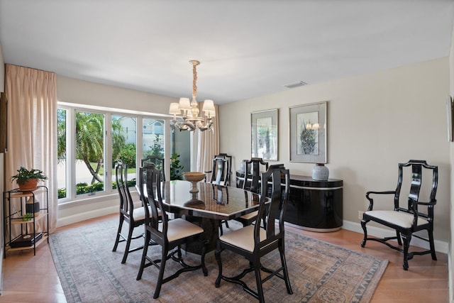 7 Inlet Cay Dr, Ocean Ridge, FL 33435 - dining area with an inviting chandelier, visible vents, baseboards, and a healthy amount of sunlight