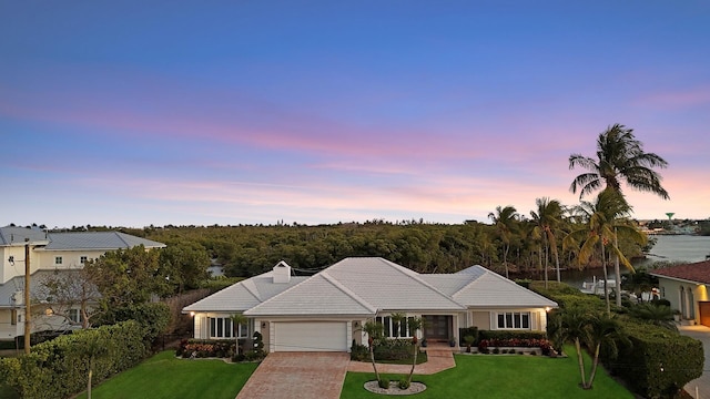 7 Inlet Cay Dr, Ocean Ridge, FL 33435 - single story home featuring a front yard, a tiled roof, driveway, and a garage