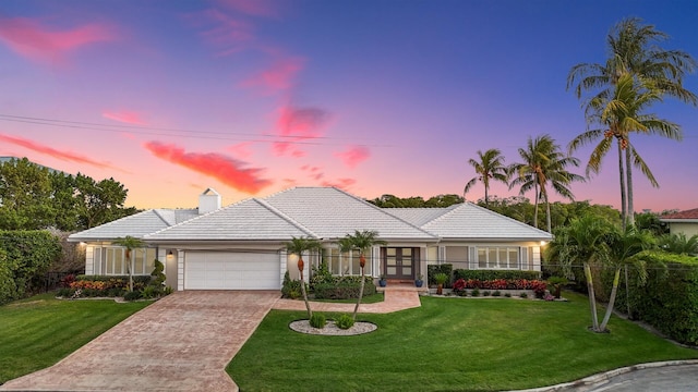 7 Inlet Cay Dr, Ocean Ridge, FL 33435 - ranch-style house featuring an attached garage, driveway, french doors, and a tile roof