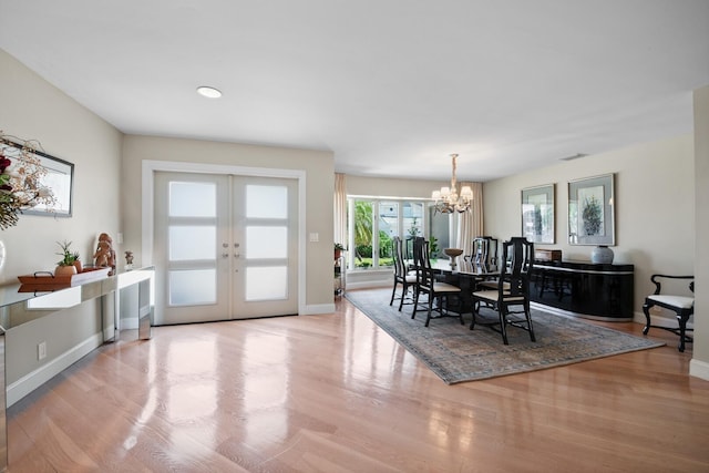 7 Inlet Cay Dr, Ocean Ridge, FL 33435 - dining space featuring a chandelier, french doors, and wood finished floors