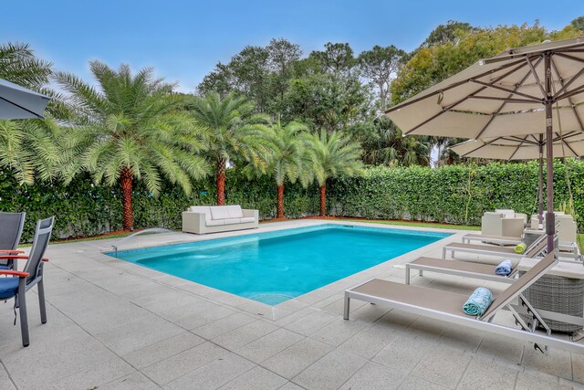 8086 Bautista Way, Palm Beach Gardens, FL 33418 - view of pool featuring an outdoor living space, a fenced in pool, a fenced backyard, and a patio area
