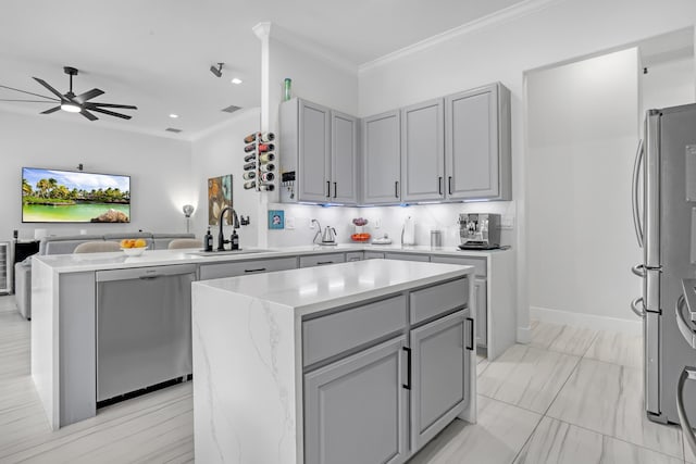 8086 Bautista Way, Palm Beach Gardens, FL 33418 - kitchen featuring a sink, a center island, a ceiling fan, appliances with stainless steel finishes, and gray cabinetry