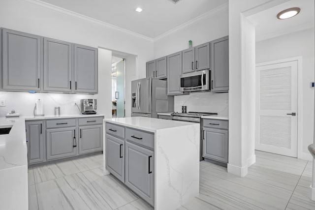 8086 Bautista Way, Palm Beach Gardens, FL 33418 - kitchen featuring ornamental molding, light stone countertops, a center island, gray cabinets, and appliances with stainless steel finishes