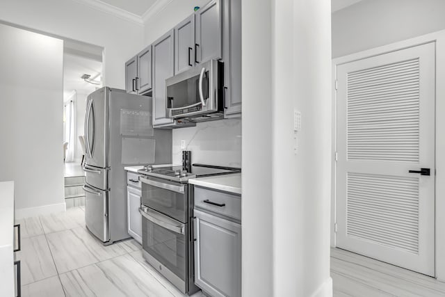 8086 Bautista Way, Palm Beach Gardens, FL 33418 - kitchen featuring crown molding, light countertops, appliances with stainless steel finishes, and gray cabinetry