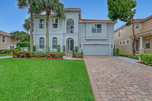 8086 Bautista Way, Palm Beach Gardens, FL 33418 - mediterranean / spanish-style home with a tiled roof, a garage, decorative driveway, a balcony, and a front lawn