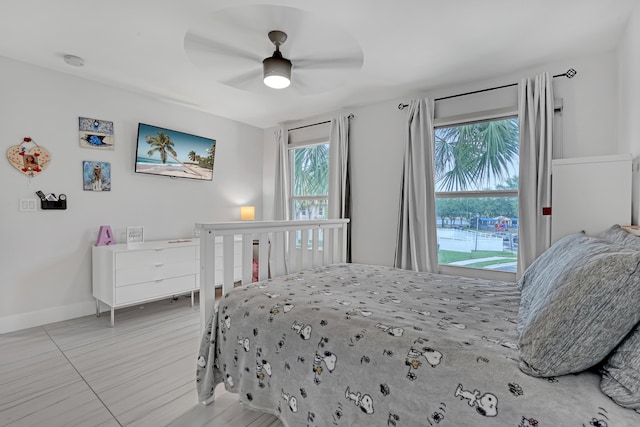 8086 Bautista Way, Palm Beach Gardens, FL 33418 - bedroom featuring a ceiling fan, baseboards, and multiple windows