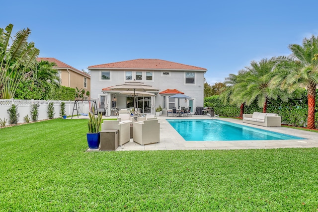 8086 Bautista Way, Palm Beach Gardens, FL 33418 - back of property with an outdoor living space, a lawn, a patio area, a fenced in pool, and a fenced backyard
