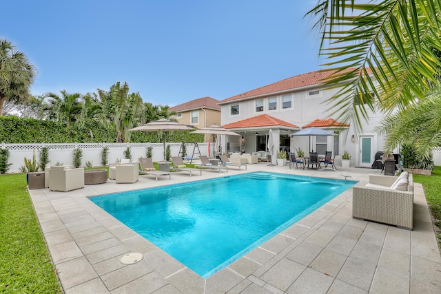 8086 Bautista Way, Palm Beach Gardens, FL 33418 - view of swimming pool featuring an outdoor living space, fence, a fenced in pool, a patio, and outdoor dining space