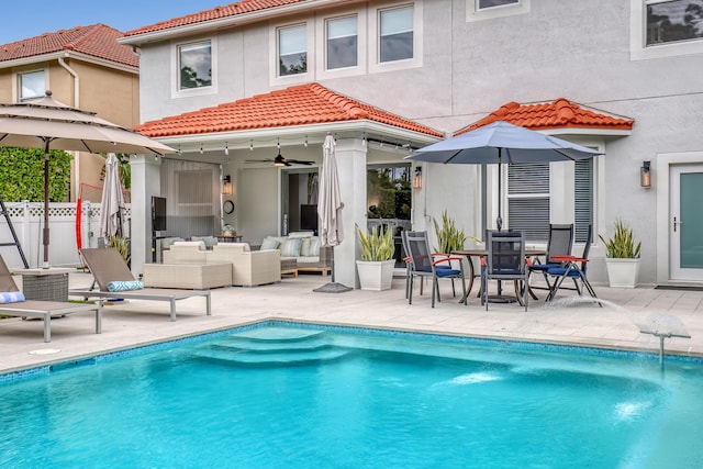 8086 Bautista Way, Palm Beach Gardens, FL 33418 - back of house featuring fence, outdoor lounge area, a ceiling fan, and stucco siding