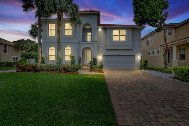 8086 Bautista Way, Palm Beach Gardens, FL 33418 - mediterranean / spanish house featuring an attached garage, stucco siding, a front yard, a balcony, and driveway