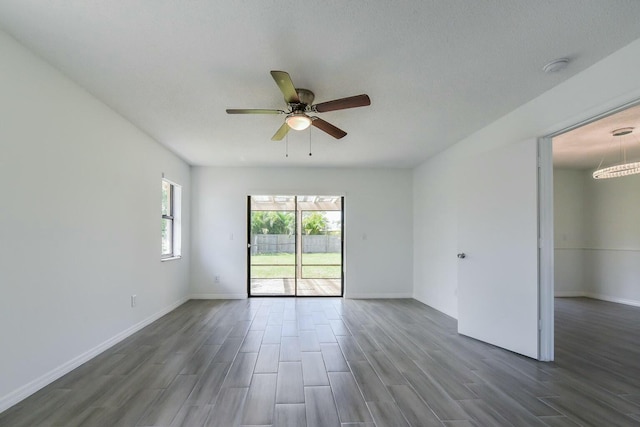 1168 SE Clifton Ln, Port Saint Lucie, FL 34983 - spare room with dark wood-style flooring, baseboards, and ceiling fan