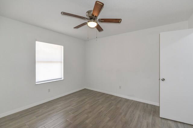 1168 SE Clifton Ln, Port Saint Lucie, FL 34983 - unfurnished room featuring wood finished floors, ceiling fan, and baseboards