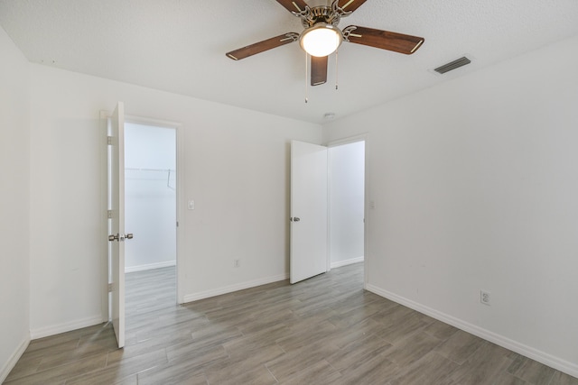 1168 SE Clifton Ln, Port Saint Lucie, FL 34983 - spare room with wood finished floors, ceiling fan, and baseboards