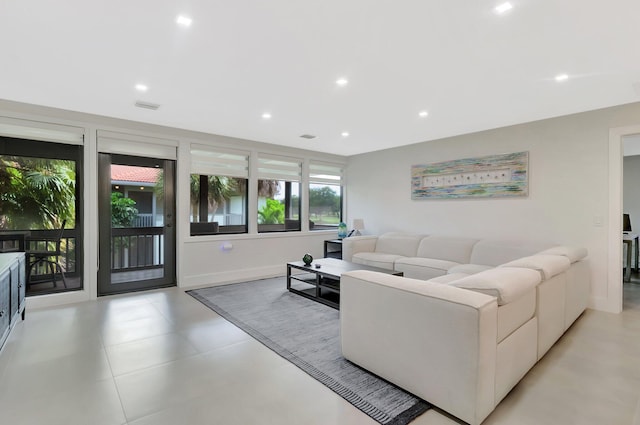 living area featuring recessed lighting, baseboards, and visible vents