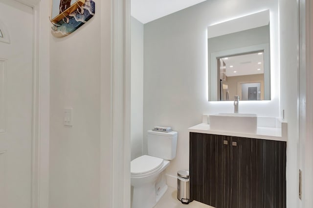 bathroom with toilet and vanity