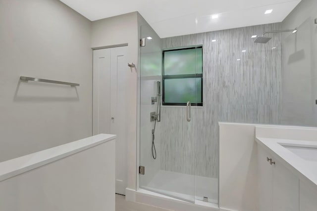bathroom featuring vanity and a shower stall