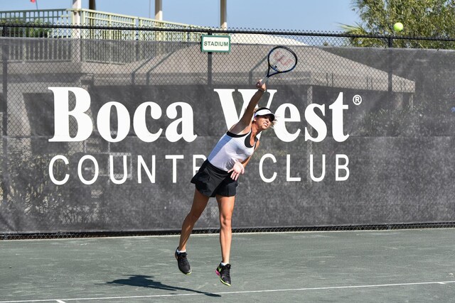 view of tennis court featuring fence