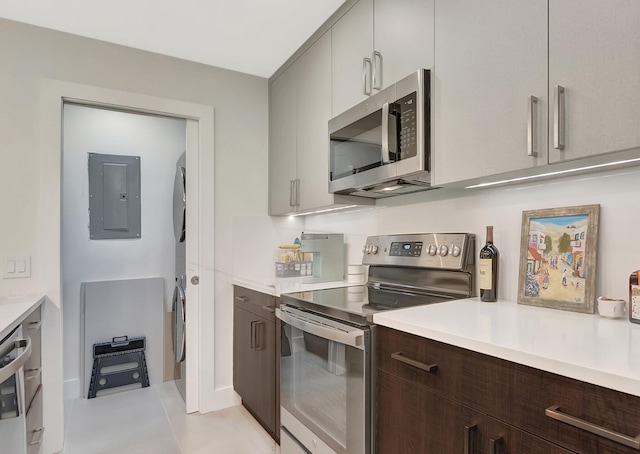 kitchen with light countertops, dark brown cabinets, electric panel, and appliances with stainless steel finishes