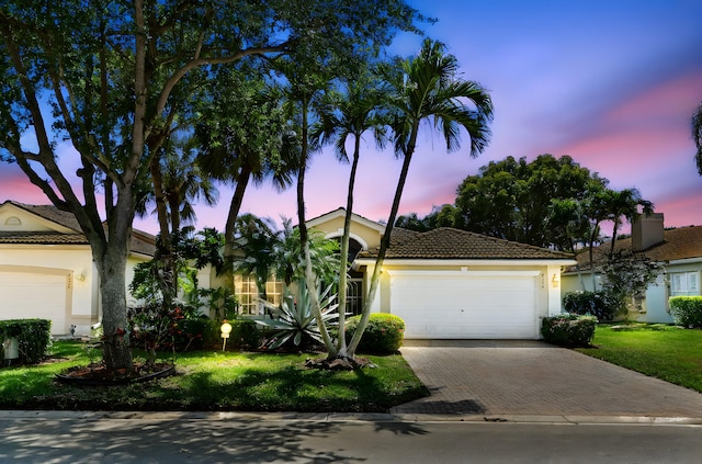 6594 Hawaiian Ave, Boynton Beach, FL 33437 - view of front facade featuring a tile roof, driveway, stucco siding, and an attached garage