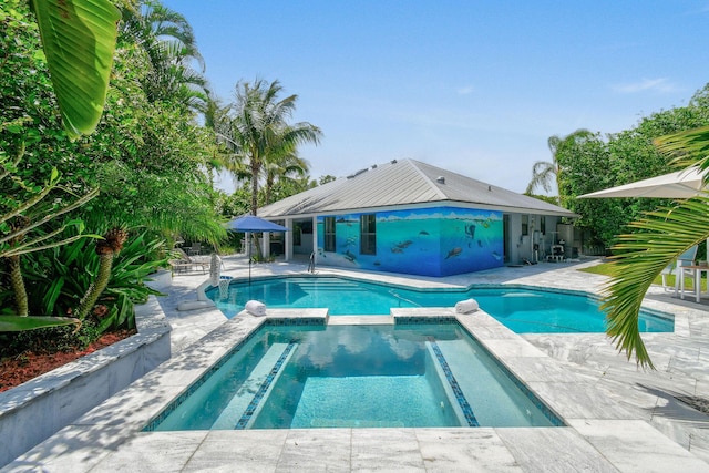 view of pool with a pool with connected hot tub and a patio