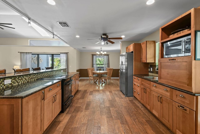 kitchen featuring dark wood finished floors, ceiling fan with notable chandelier, a sink, and stainless steel appliances