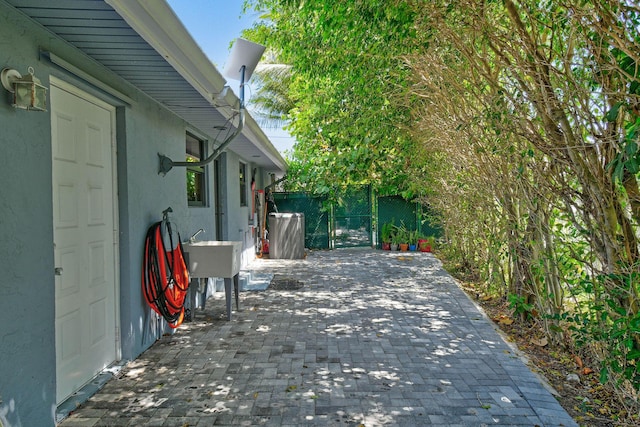 view of patio / terrace featuring a gate, fence, and a sink
