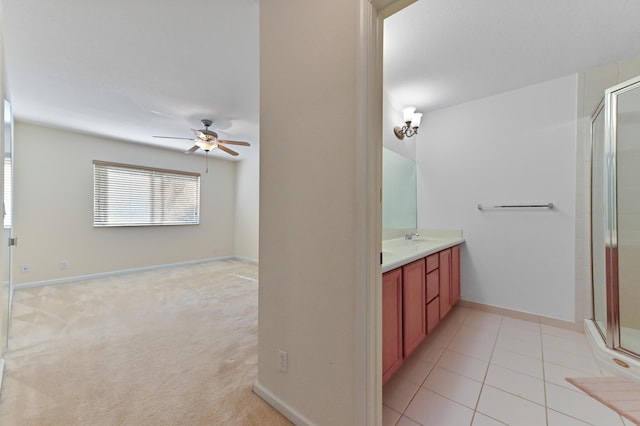 3119 N Evergreen Cir, Boynton Beach, FL 33426 - bathroom featuring a ceiling fan, vanity, a shower stall, baseboards, and tile patterned floors