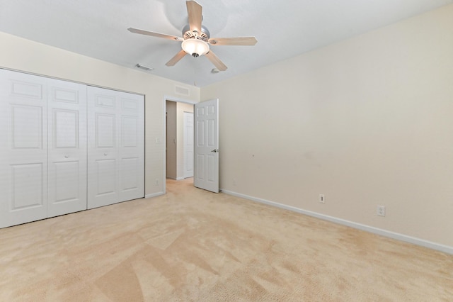 3119 N Evergreen Cir, Boynton Beach, FL 33426 - unfurnished bedroom featuring light colored carpet, baseboards, a closet, and a ceiling fan