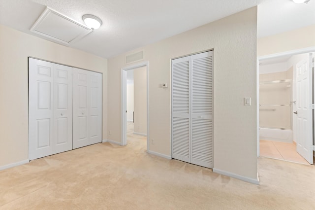 3119 N Evergreen Cir, Boynton Beach, FL 33426 - unfurnished bedroom featuring multiple closets, carpet, and attic access