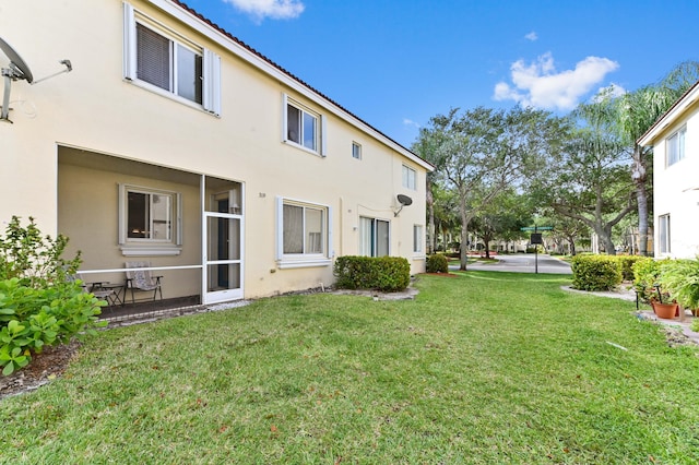 3119 N Evergreen Cir, Boynton Beach, FL 33426 - rear view of property featuring stucco siding and a lawn