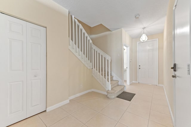 3119 N Evergreen Cir, Boynton Beach, FL 33426 - foyer entrance featuring light tile patterned floors, baseboards, and stairway