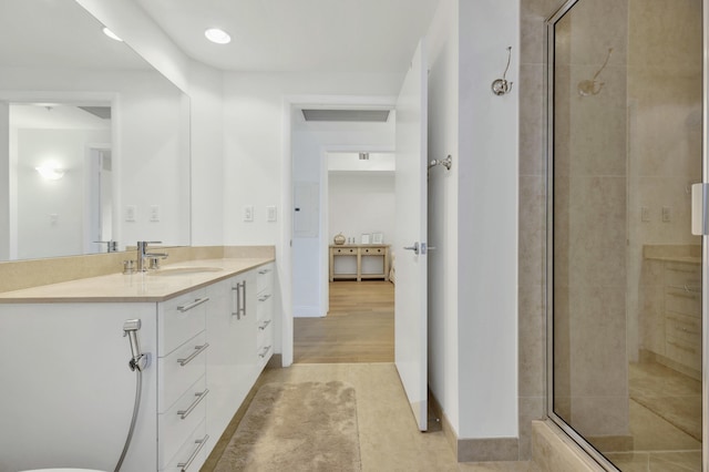 full bathroom featuring baseboards, recessed lighting, vanity, a stall shower, and tile patterned flooring